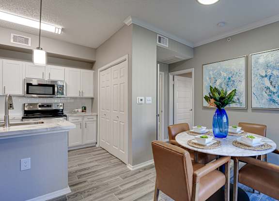Dining area with kitchen and vaulted ceiling at Carmel Creekside Apartments, Fort Worth, Texas