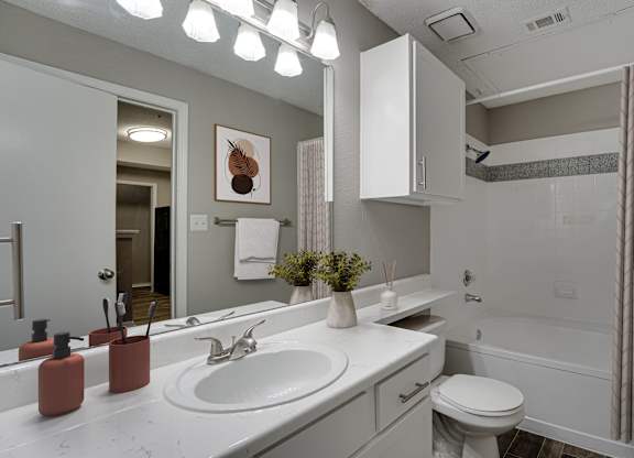 Full bathroom with tub shower combo and vanity at Carmel Creekside Apartments, Fort Worth, Texas