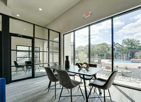 Clubhouse dining room with floor to ceiling windows at Carmel Creekside Apartments, Fort Worth, TX