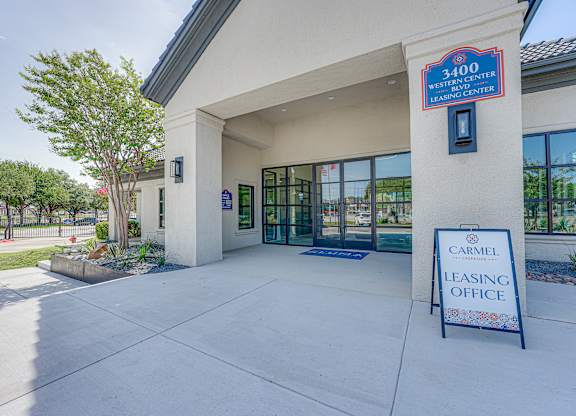 Leasing office entrance with glass doors and signage at Carmel Creekside Apartments, Texas