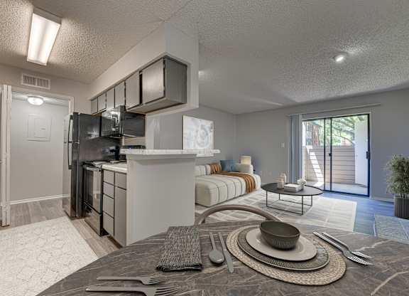 A modern kitchen with a breakfast table set up in the middle at Indian Creek Apartments, Carrollton, TX, 75007