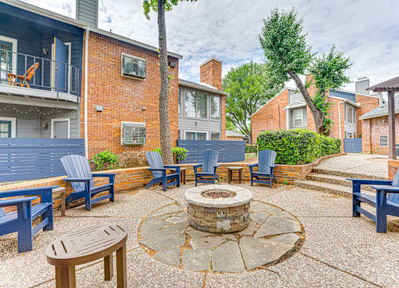 A courtyard with a fire pit and seating area.