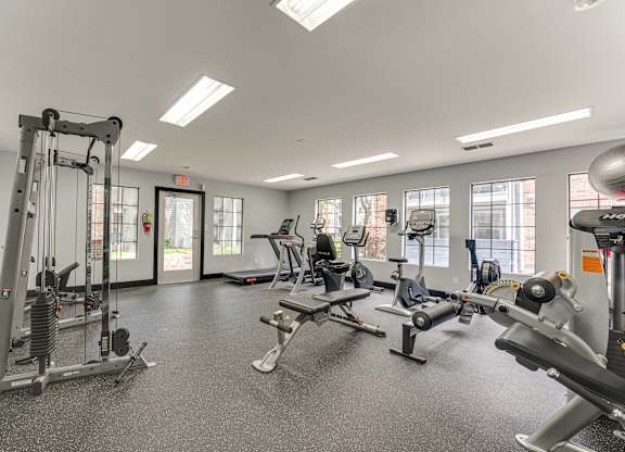 A spacious gym with various exercise equipment.
