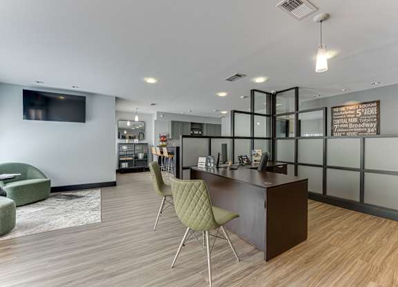 A modern office space with a reception desk and chairs.