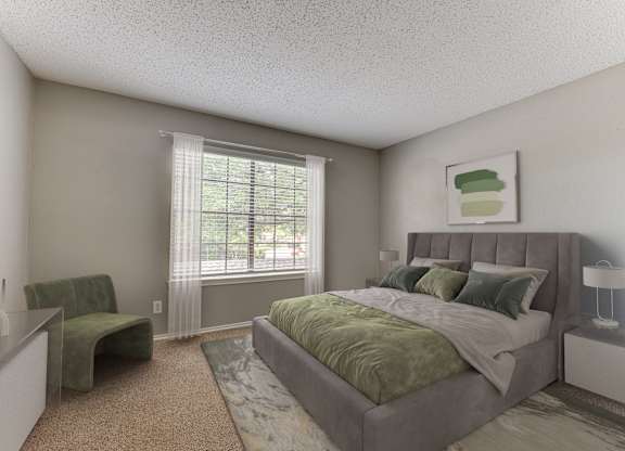 A bedroom with a large bed and a green chair.