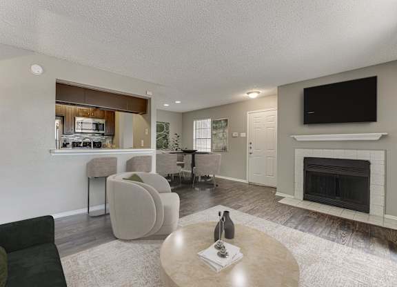 A living room with a fireplace and a television.