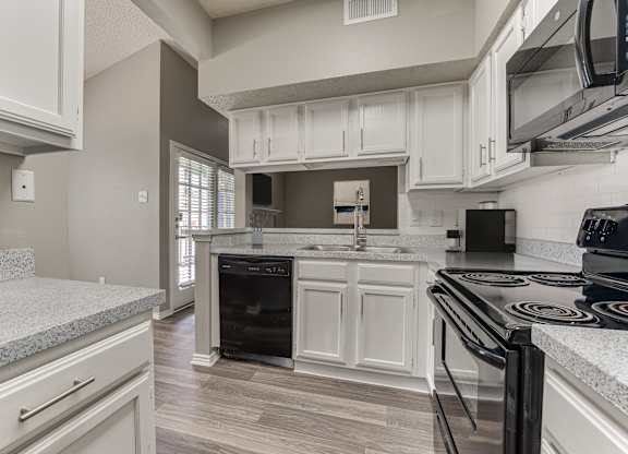 A kitchen with a black stove top oven.
