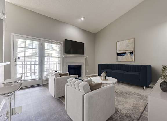 A living room with a fireplace and a television.