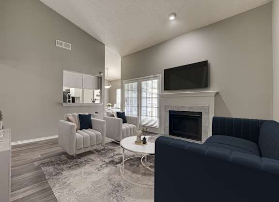 A living room with a fireplace and a television.
