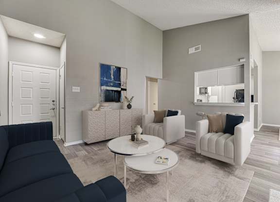 A living room with a dark blue sofa and a white coffee table.