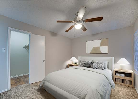 Grey bed in bedroom at Timberglen Apartments, Texas