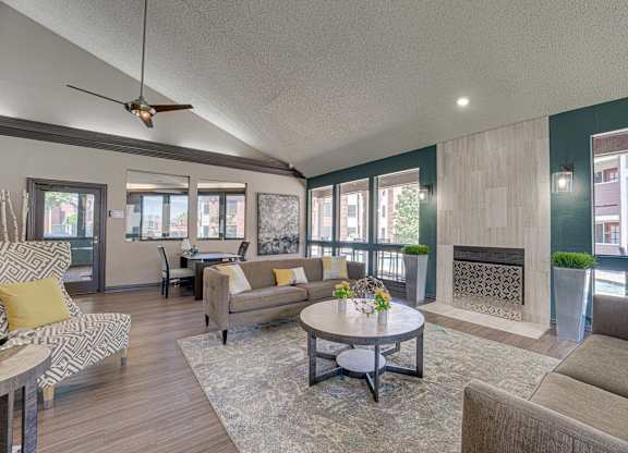 living room with a fireplace and a ceiling fan at Timberglen Apartments, Dallas Texas