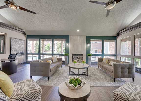 living room with a grey couch at Timberglen Apartments, Dallas