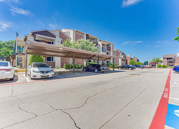 parking lot with cars at Timberglen Apartments, Dallas, TX