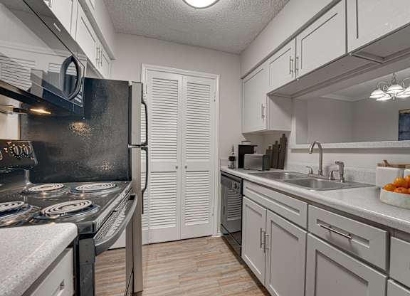 kitchen with a black stove top oven at Timberglen Apartments, Texas, 75287
