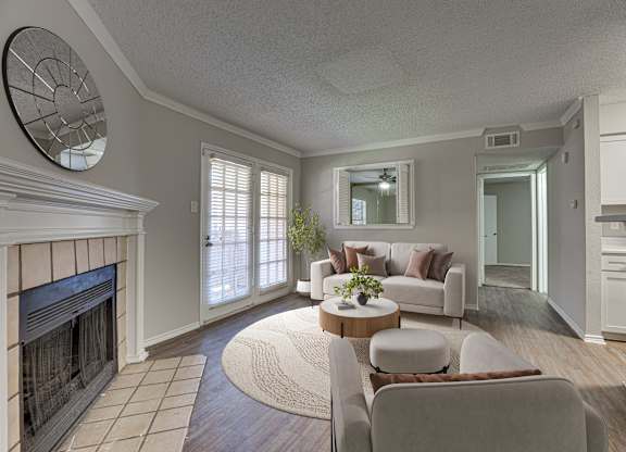 Wall clock and chairs in a room at Timberglen Apartments, Texas