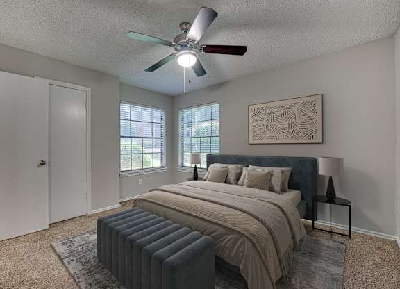 bedroom with bed and window with blinds at Timberglen Apartments, Texas