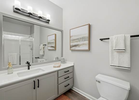 A white toilet sits next to a sink in a bathroom.