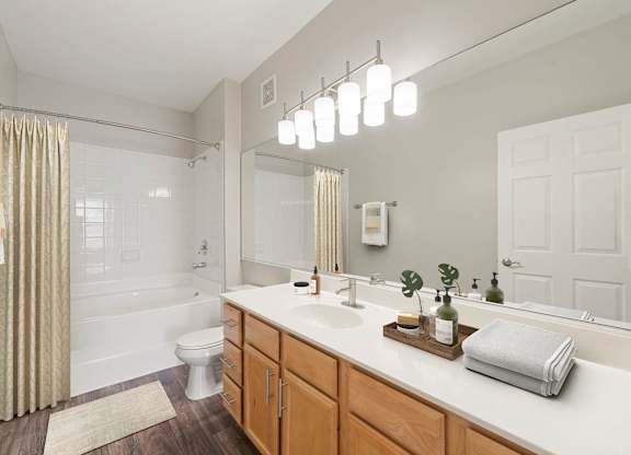 A bathroom with a white countertop and a white sink.