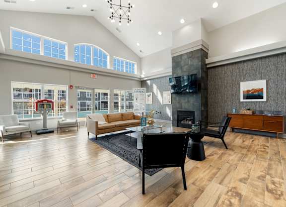 A living room with a black piano in the middle.
