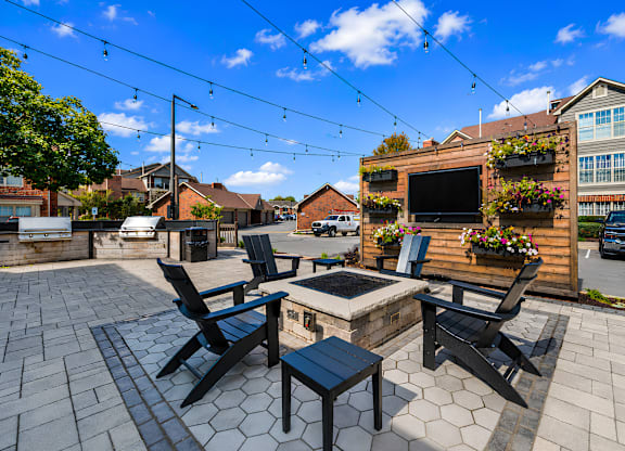 A patio with a table, chairs and a television.