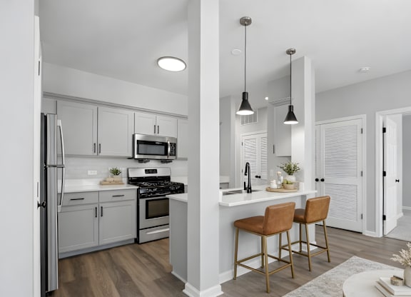 A modern kitchen with white cabinets and a wooden island.