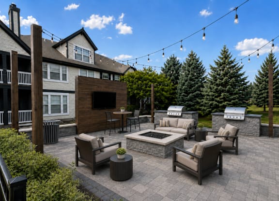 A patio with a fireplace and seating area.