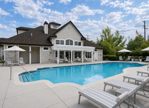 A large house with a pool in the backyard.