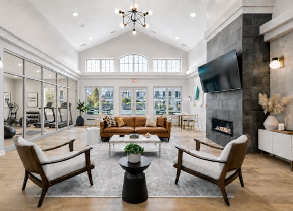 A modern living room with a fireplace and a television.