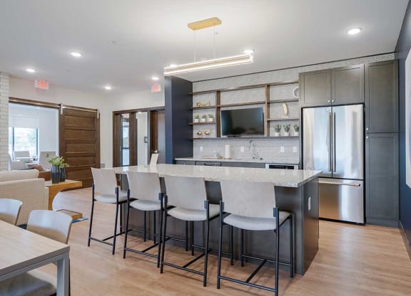 a kitchen with a large island with bar stools