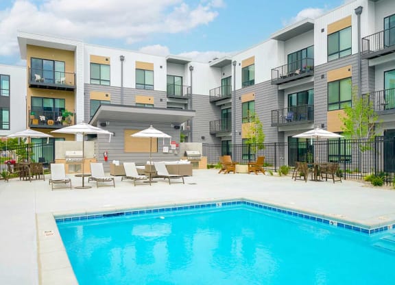 a swimming pool in front of some apartment buildings