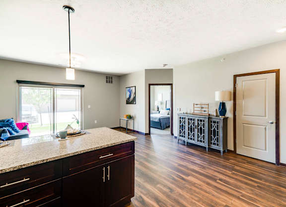 A kitchen with dark wood floors and cabinets.