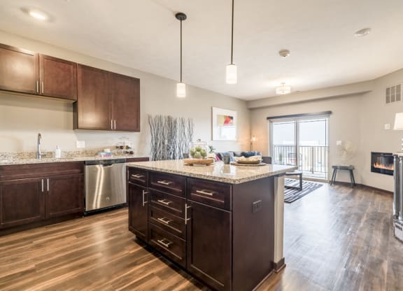 View from kitchen island with hardwood-style floors in one bedroom apartment for rent at 360 at Jordan West best new apartments West Des Moines IA 50266