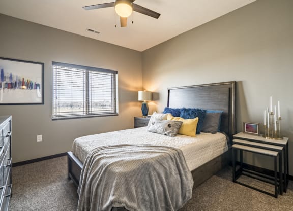 Bedroom with ceiling fan and natural lighting at 360 at Jordan West best new apartments West Des Moines IA 50266