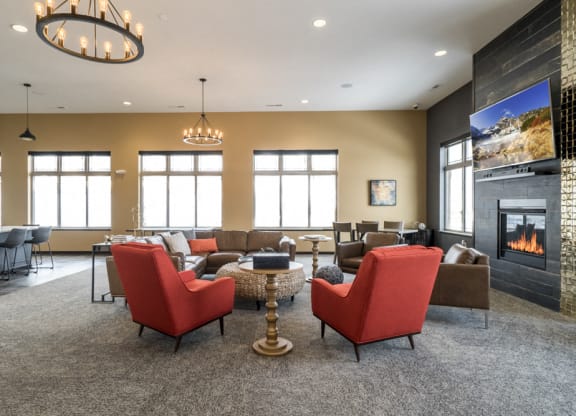Clubhouse interior with seating, TV and fireplace at 360 at Jordan West best new apartments West Des Moines IA 50266