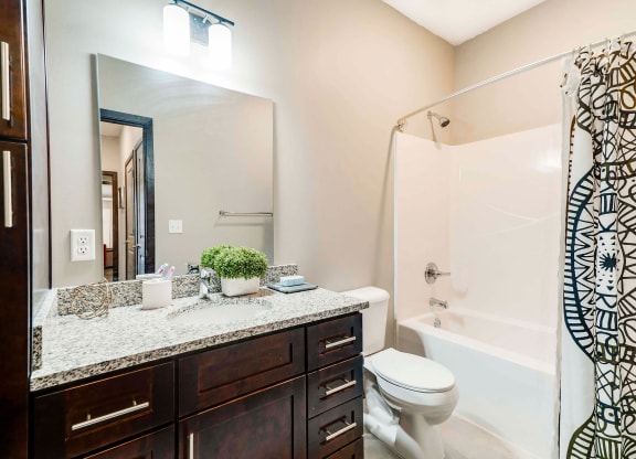 Spacious bathroom with tub shower and granite countertops in 2 bedroom apartment for rent at 360 at Jordan West best new apartments West Des Moines IA 50266