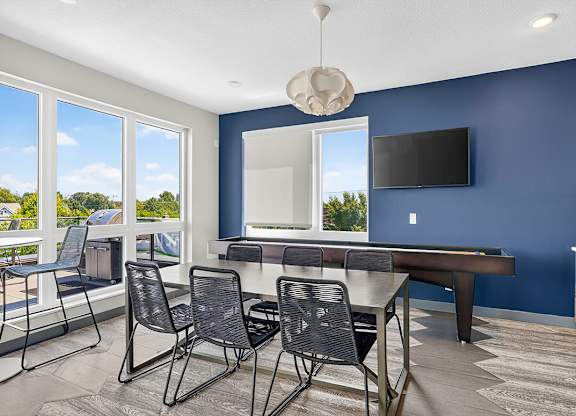 A room with blue walls and a table with chairs.