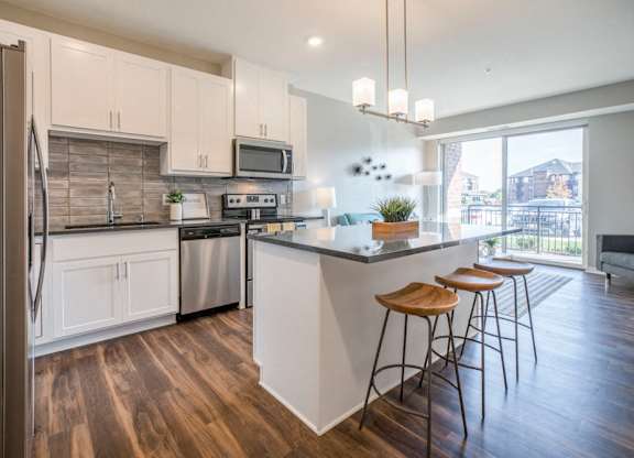 Kitchen with pendant lighting and island at Ascend at Woodbury new luxury apartments in Woodbury MN 55129