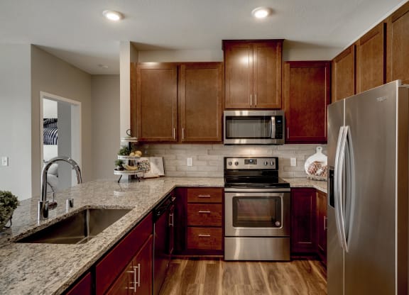 Luxury apartment with dark cabinetry and granite countertops at Ascend at Woodbury MN 55129 new luxury apartments