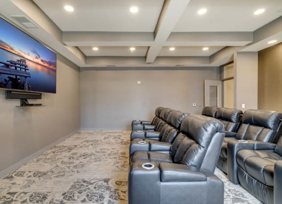 Theater room with leather seating and large TV at Ascend at Woodbury MN