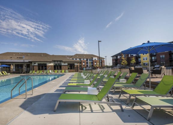Lounge chairs next to resort-style pool at Ascend at Woodbury new luxury apartments in Woodbury MN 55129