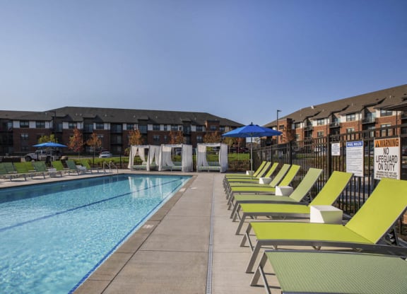 Outdoor swimming pool with cabanas and lounge chairs at Ascend at Woodbury MN 55129 new luxury apartments