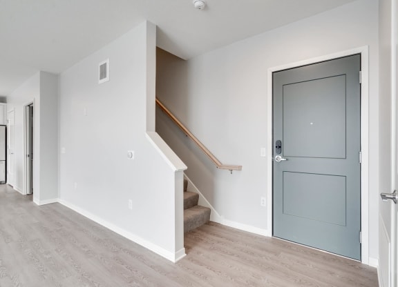 Entryway and carpeted staircase leading to second floor at Aspire at CityPlace in Woodbury, Minnesota