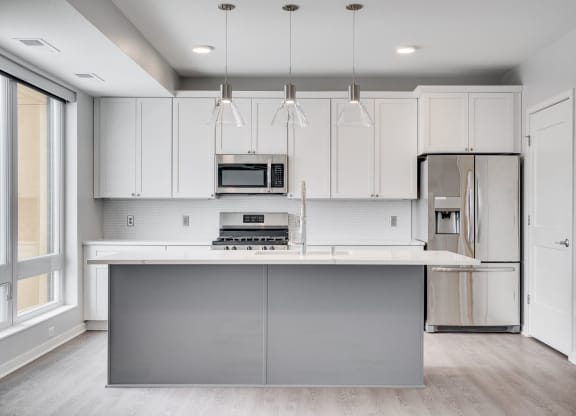 Beautiful kitchen with light luxury finishes, matching stainless steel appliances, and granite countertops