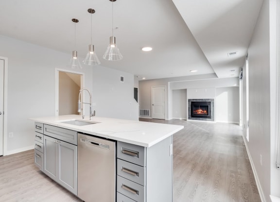 Large kitchen island with granite countertops and dishwasher in island