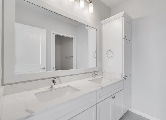 Large dual sink vanity in luxury bathroom at Aspire at CityPlace in Woodbury, Minnesota