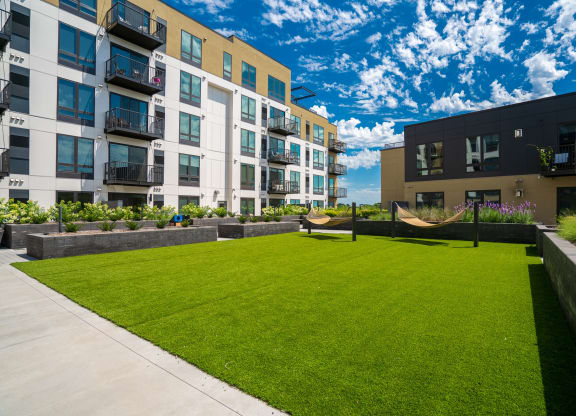 Courtyard hammock grove with a couple hammocks in grassy area at Aspire at Cityplace.