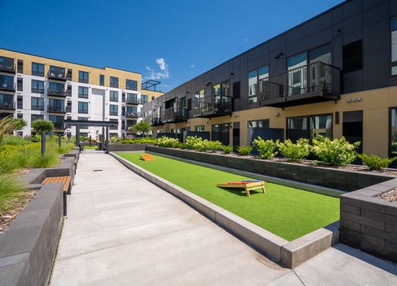 Courtyard outdoor area with cornhole playing area at Aspire at CityPlace
