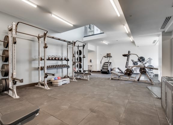 Strength training room with cushioned flooring in the fitness center at Aspire at CityPlace