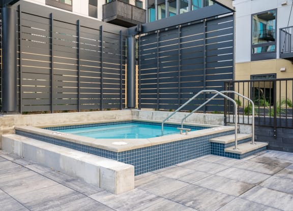 Square spa hot tub with walk in stairs at luxury apartment in Woodbury MN 55125